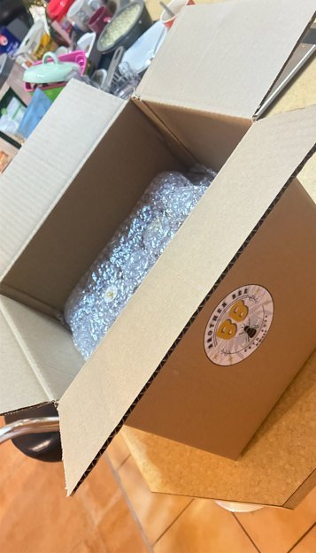 A Brother Bee ZA branded box, packed with honey wrapped in bubble wrap, ready for a bulk order